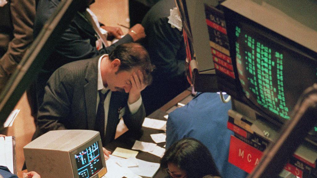 In this 19/10/1987 file photo, a trader reacts as stocks are devastated as one of the most frantic days in the history of Wall Street sent the Dow Jones plummeting over 200 points in the heaviest day at the New York Stock Exchange. The day became known as Black Monday.